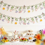Two pieces of Ghegicu waterproof floral party banner draped elegantly along an outdoor garden fence decoration.