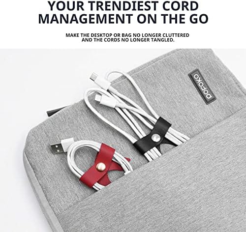 Five pink leather cable management straps arranged neatly on an office desk.