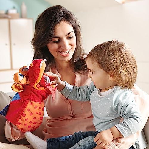 HABA interactive monster puppet swallowing a plastic rattling ball into its clear mesh belly bag.