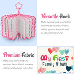 Fintie mini toddlers scrapbook hanging from a stroller handle by its built in clip