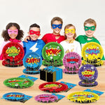 Top down view of full superhero birthday table setting for 24