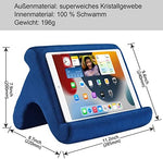Navy blue premium soft device dock being used on a living room couch