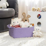 MEGASKET cotton rope organizer basket being carried by its sturdy built-in side handles.