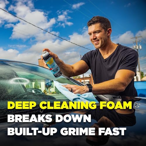 Streak free glass cleaner spray being applied to a tinted car window