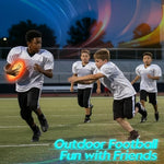 Waterproof Flashglow LED football on a grass lawn during evening family play