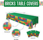 Extra large rectangular brick themed plastic tablecloth unfolded on a party table displaying vibrant interlocking block designs.