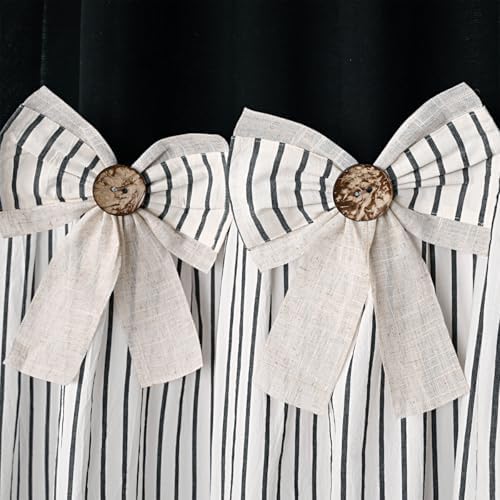 Detailed shot of the beige bowknot embellishments on the yarn dyed weave of the farmhouse shower curtain.