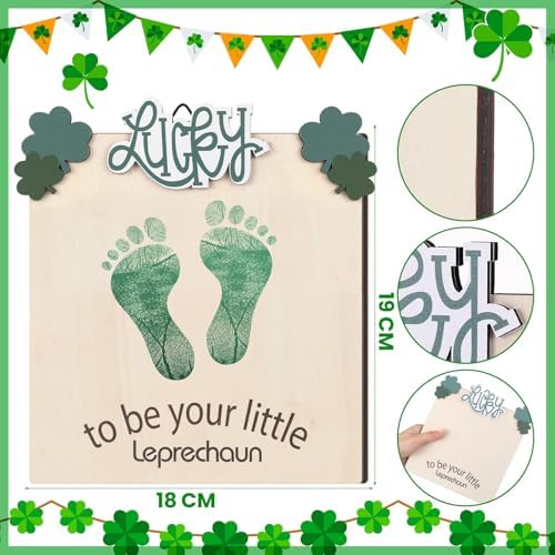 Beeveer newborn footprint keepsake disc styled as a photography prop next to baby clothes.