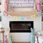 Pastel velvet ribbon garland draped elegantly along an indoor staircase railing for a spring themed party.