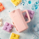 Side angle view of the non toxic BPA free Rinzee silicone baby cup highlighting its ergonomic grip.