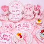 Detailed view of Redword paper party cups with pink bow design