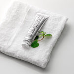 Marvis Whitening Mint Toothpaste creamy texture paste squeezed onto a toothbrush