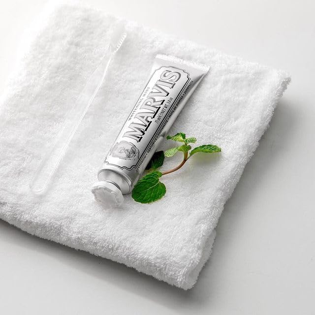 Marvis Whitening Mint Toothpaste creamy texture paste squeezed onto a toothbrush
