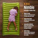 Jirni portable toddler floor bed rolled up compactly next to standard travel luggage.