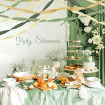 Kiwayo pastel paper streamers hanging from the ceiling to create a woodland safari themed backdrop.