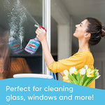 Windex glass cleaner being used on a mirror for smudge removal.