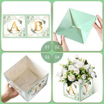 Close up of sage green floral patterned party favor boxes