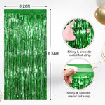 Two pack green foil streamers used as a party photo booth background