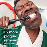 Quip 360 electric toothbrush handle attached to a bathroom mirror using the magnetic travel mount