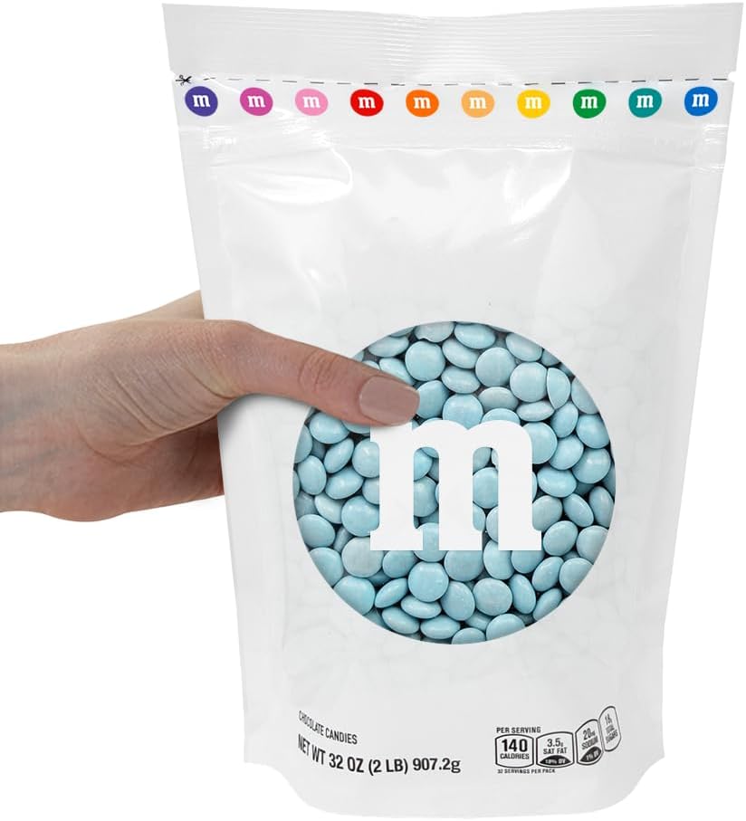 M&M'S World light blue chocolate buttons displayed in a transparent glass bowl for wedding decor