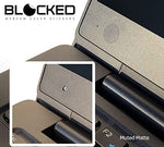 Close-up of a muted matte black vinyl camera sticker applied to a laptop webcam lens area