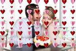 Pre strung red and pink 3D heart paper garlands arranged on a backdrop wall