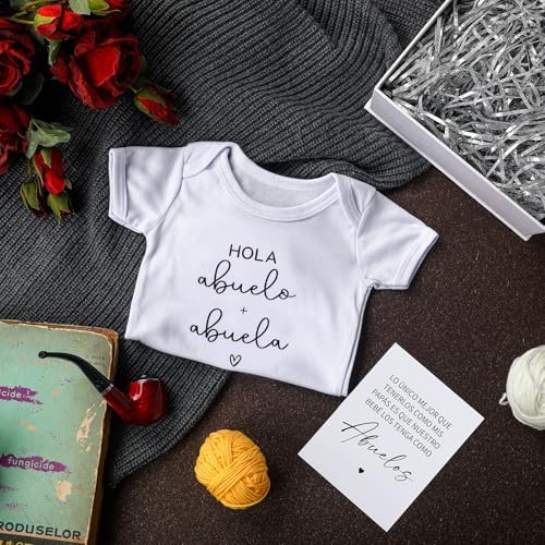 Shyyween pregnancy reveal card with spanish text laid flat on silver raffia grass