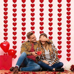 Adjustable spacing feature of the AinDen romantic hanging hearts being spread out on a white wall backdrop
