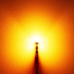 Phinlion W5W replacement wedge base bulb glowing in brilliant amber yellow