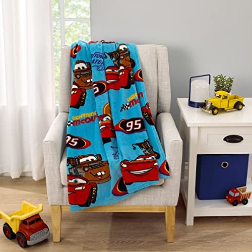 Side view of the NoJo Disney Cars blanket showing vibrant blue and red character print.