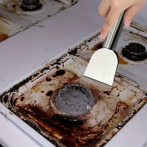 Hand holding Auhsgch scraper cleaning burnt grease off a kitchen stove top