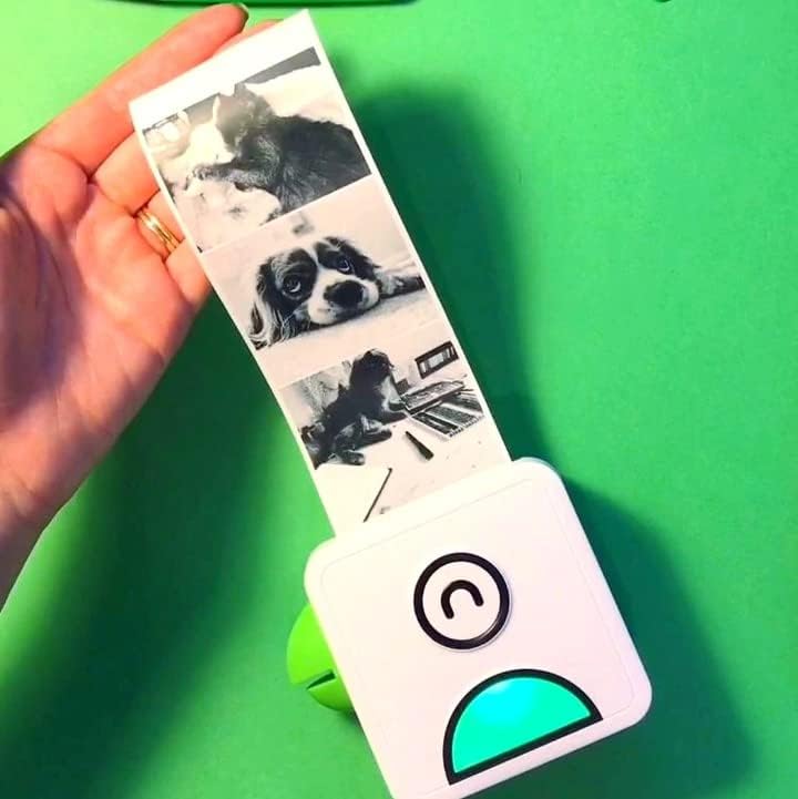 Handheld view of the travel-friendly Poooliprint inkless sticker printer for scrapbooking.