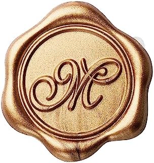 Close up of Yoption gold M wax seal sticker on envelope