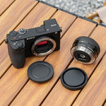JJC protective body cover and lens back cap separated to display premium ABS plastic build quality.