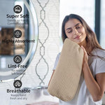 Lifestyle shot of beige hand towel hanging in a modern bathroom