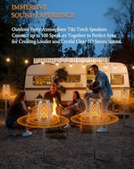 Two wireless party speakers synced together broadcasting 360 degree hd stereo sound during an evening backyard gathering