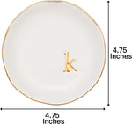 White ceramic ring dish with gold trim on nightstand