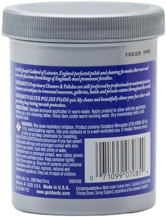 Authentic Goddard's silver cleaner foam removing tarnish from intricate silver ornaments.