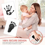 Detailed dog paw print and newborn baby handprint side by side on impression cards