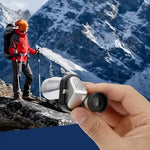 Portable handheld mini monocular pocket telescope for adults being held to demonstrate compact size