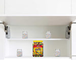 Assorted milk chocolate candy pieces spilled next to the premium yellow lid party size jar