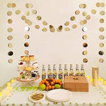 Pre strung champagne gold circle paper banner draped over a birthday party table setup