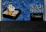 Lifestyle shot of the executive mini sandbox placed on an office table next to a laptop for workplace stress relief.