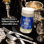 Intricate silver filigree earring being cleaned with Goddard's Silver Dip solution.