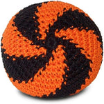 A person stalling a colorful DIRTBAG crochet hacky sack on the inside of their shoe during an outdoor game.