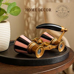 Compact pink enamel brass binoculars placed as luxury vanity table decor