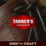 Close-up of Tanner's Preserve leather conditioner being applied to a premium leather sofa to reverse dryness.