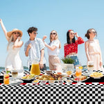 Side angle shot of WNINK racetrack rectangular table cover protecting a wood table from spilled party drinks