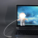 SOONDAR astronaut keyboard lamp with its flexible gooseneck arm twisted at a forty-five degree angle
