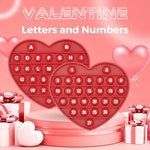 Durable heart shaped alphabet learning toy being pressed for tactile play
